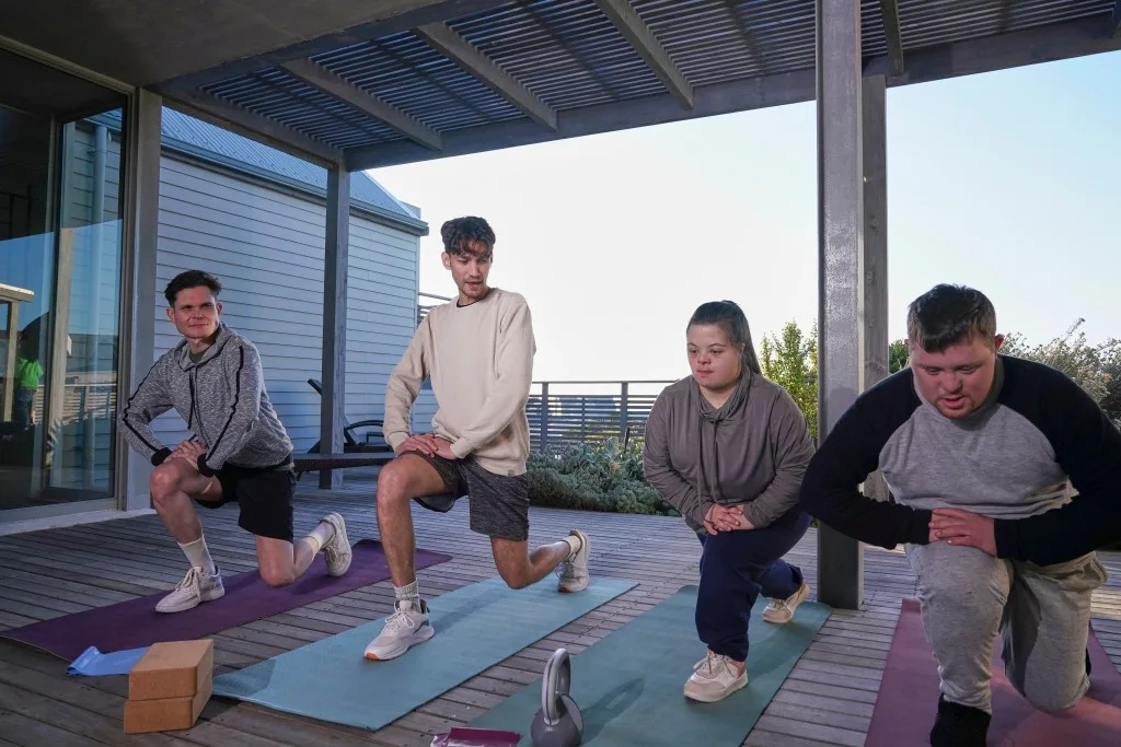 Group of diverse friends doing stretching exercises at home